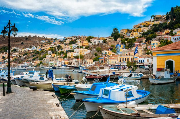 Sailboats moored in harbor by buildings in city