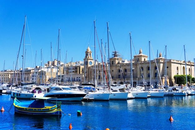 Sailboats moored in harbor