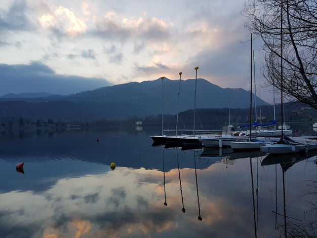 Foto barche a vela ormeggiate nel lago contro il cielo