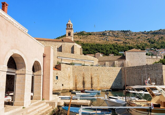 Sailboats in the Old port in the Adriatic Sea in Dubrovnik, Croatia. People on the background