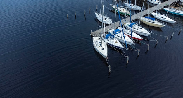 Sailboats on the pier on the lake aerial view