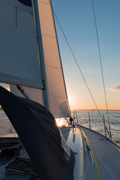 sailboats sailing on sea against sky during sunset