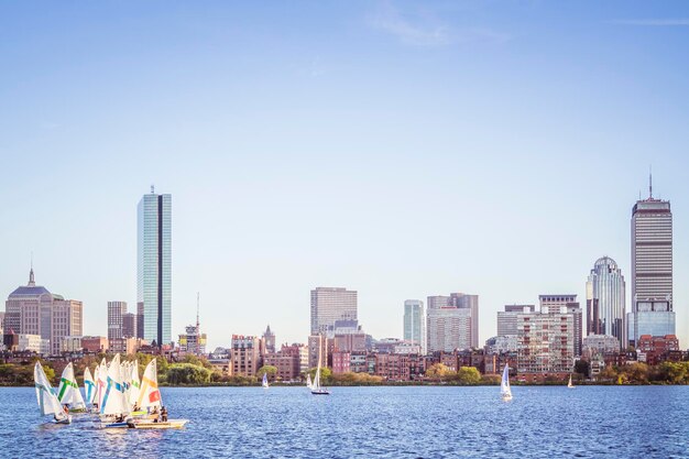 Sailing boats on a charles river with view of boston skyscrapers