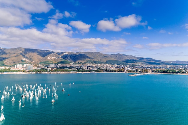 Sailing regatta in Gelendzhik Bay Numerous white sails in the emerald water of the Black Sea