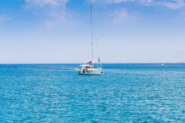 Sailing yacht in the calm blue sea