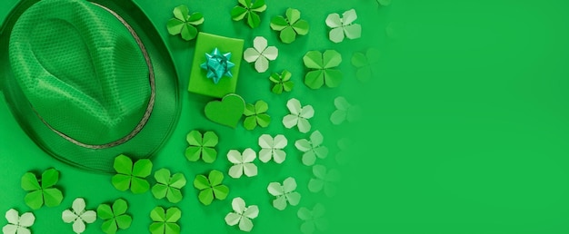 Saint Patrick's day banner with hat gift heart and paper clovers