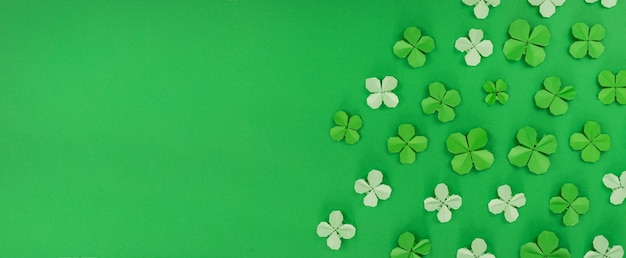 saint patrick's day banner with origami clovers leaves holiday symbol
