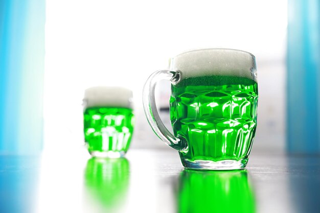 Saint Patrick's Day holiday National Irish holiday Green beer Hand with a mug of emerald beer in a bar