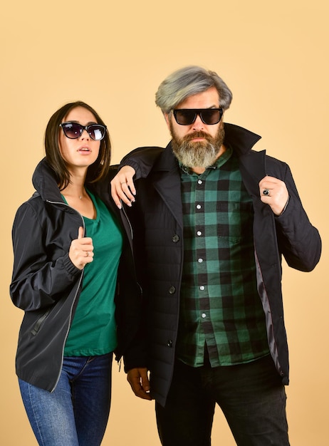 Saint Patricks day Bearded man with dyed hair checkered shirt and girl in sunglasses Fashion couple in love Fashionable couple posing Enjoying spring time together Street style Hipster couple