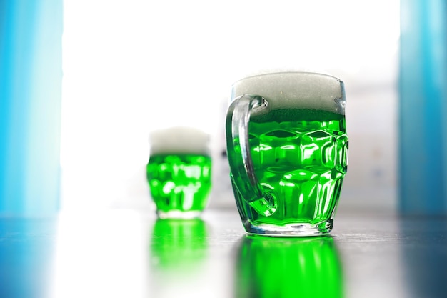 Saint Patricks Day holiday National Irish holiday Green beer Hand with a mug of emerald beer in a bar