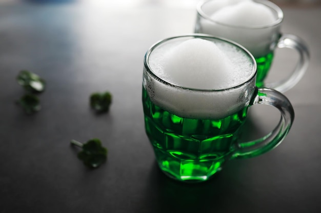 Saint patricks day holiday national irish holiday green beer\
hand with a mug of emerald beer in a bar