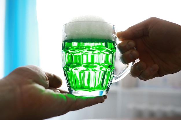 Saint patricks day holiday national irish holiday green beer
hand with a mug of emerald beer in a bar