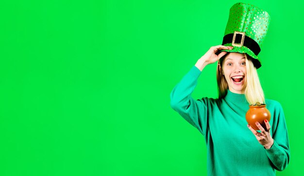 Saint patricks day surprised woman in leprechaun hat with pot of gold tradition of saint patrick day