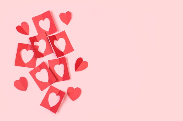 Saint valentine red paper hearts on a pink background