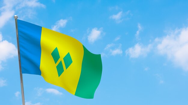 Saint Vincent and the Grenadines flag on pole. Blue sky. National flag of Saint Vincent and the Grenadines