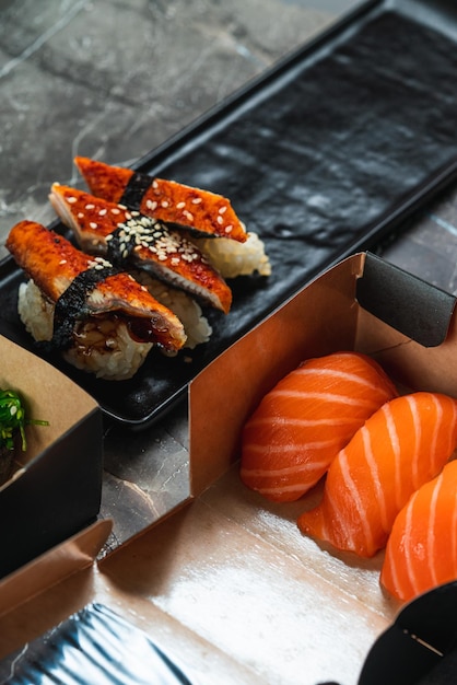 Sake sushi unagi sushi on a serving plate sushi on a dark background Japanese food