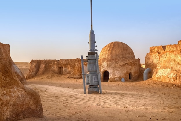 SAKHARA, Tunisia - May 17, 2021: The abandoned scenery of the planet Tatooine for the filming of Star Wars in the Sahara Desert with sand dunes in the background