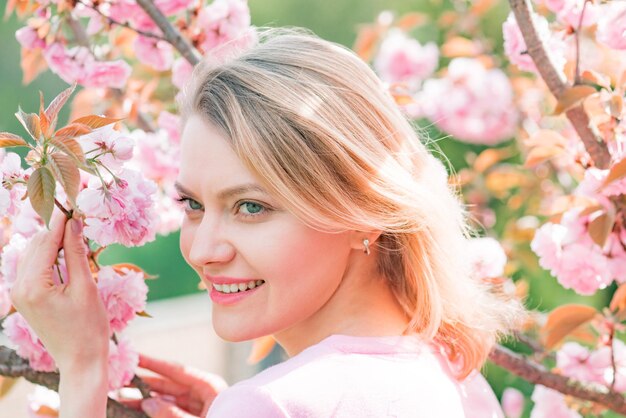 Sakura festival blonde girls with blossom cherry tree over nature background sakura