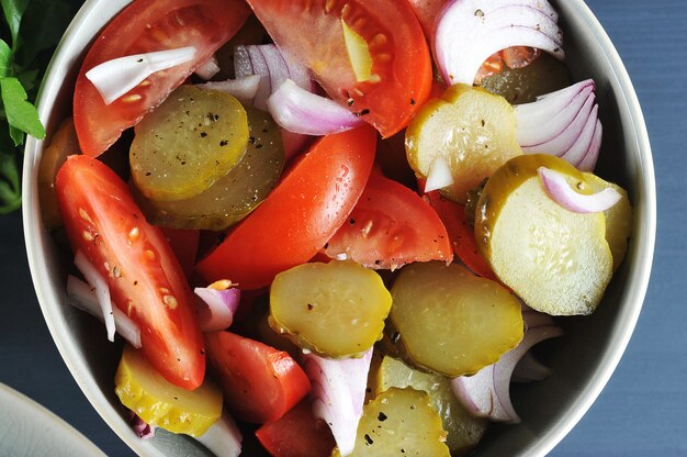 Salad appetizer with tomatoes, pickles and onions