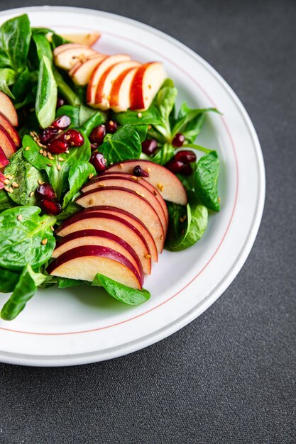 salad apple slice green mix lettuce pomegranate grain healthy meal food snack on the table