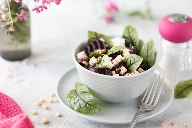 Salad of beets, cheese, green peas and pine nuts. Vegetarian salad with vegetables and fresh chard leaves.