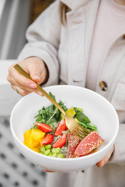 Salad bowl in girl hand