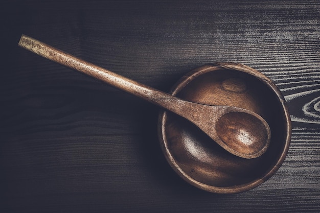 Salad bowl and spoon on brown table