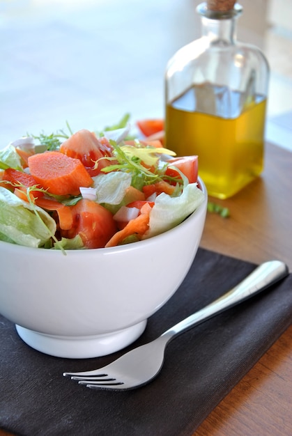 Salad bowl with lettuce, carrot, tomato and onion