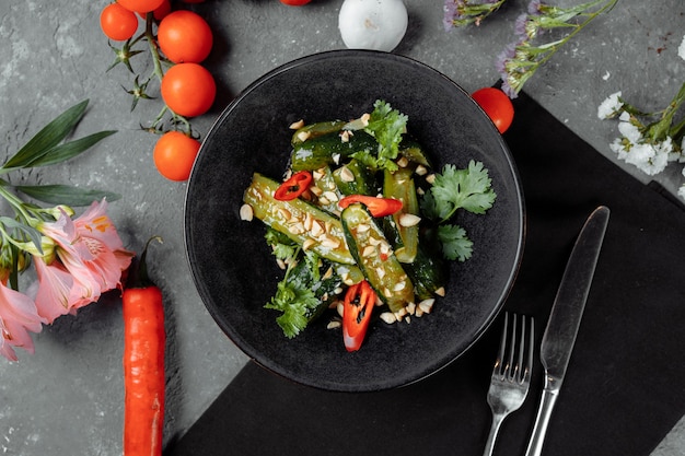 Insalata di cetrioli rotti con semi di sesamo, zucchero, pepe rosso e nero, olio d'oliva.