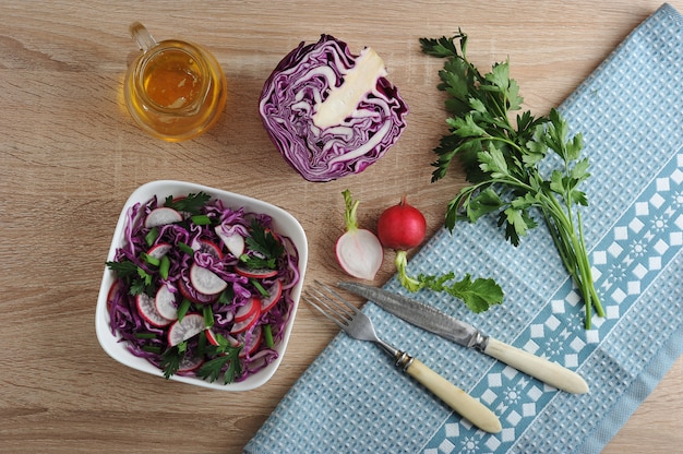 salad of cabbage and radish and parsley in the bowl