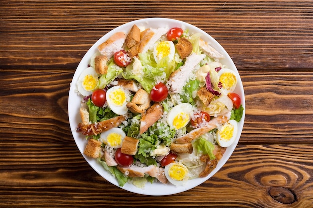 Salad ceasar with chicken eggs tomatoes and croutons