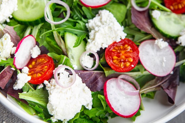 salad cheese green leaves vegetable radish tomato cucumber meal food snack on the table