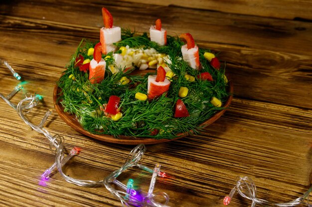 Salad christmas wreath on a wooden table