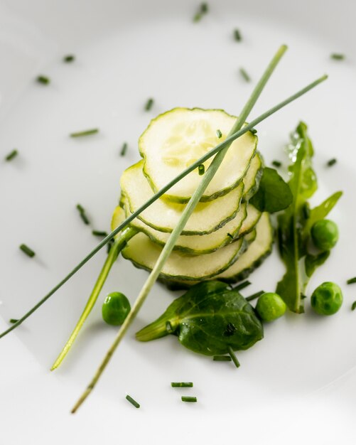 Salad of cucumbers on a white plate close-up