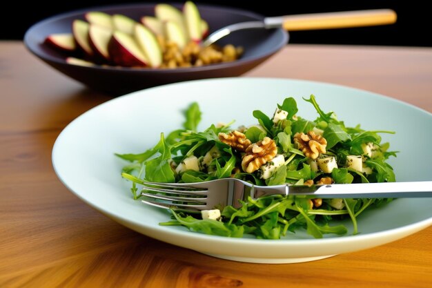 A salad fork beside a serving of fig and walnut salad