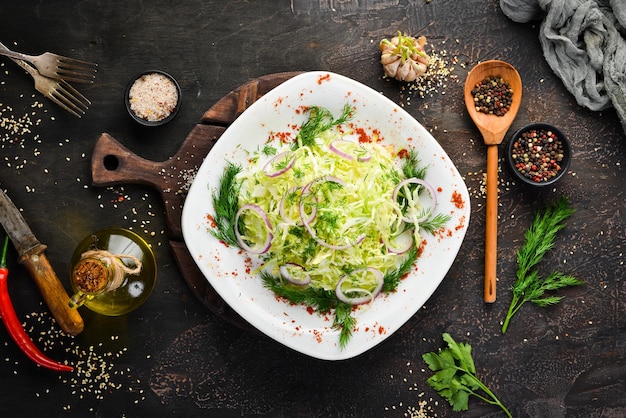 Salad of fresh cabbage and parsley in a plate On the old background free copying space