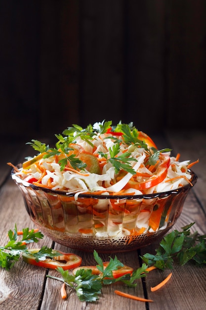 Salad of fresh cabbage, red bell pepper, carrot and parsley. Dar