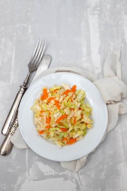 Salad fresh cabbage with carrot on white dish