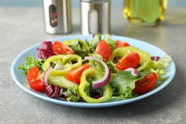 Salad of fresh vegetables on grey
