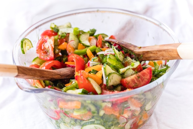 salad of fresh vegetables and olive oil in a glass plate.