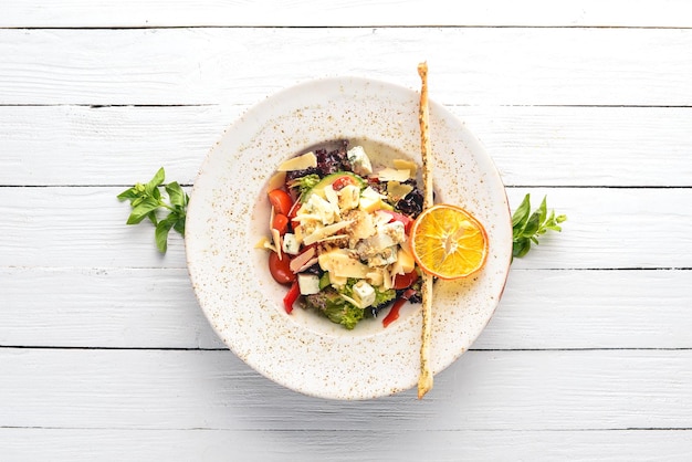 Salad of fresh vegetables with blue cheese and parmesan cheese On the old background Free copy space Top view