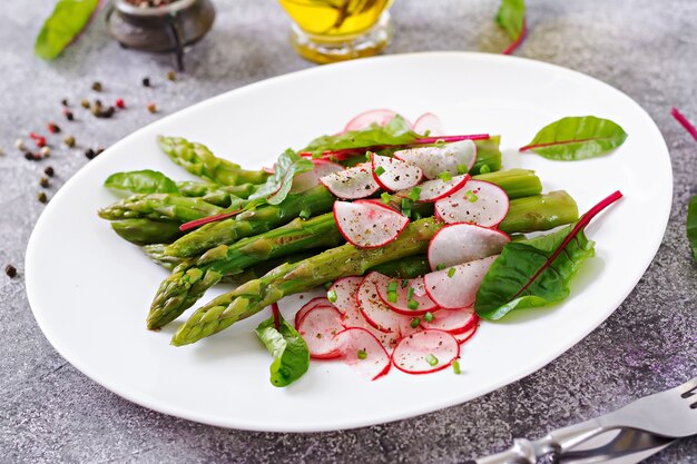 Salad from asparagus with radish and chard. Vegan cuisine. Healthy food.