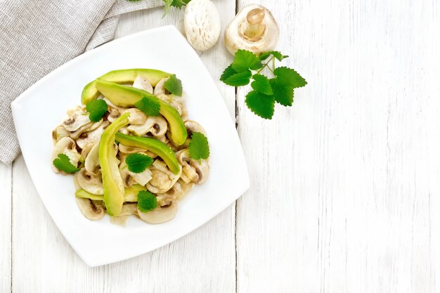 Salad from avocado and raw champignons