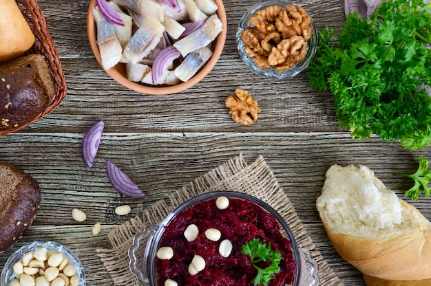 Salad from boiled beets pieces of herring with red onion nuts Top view