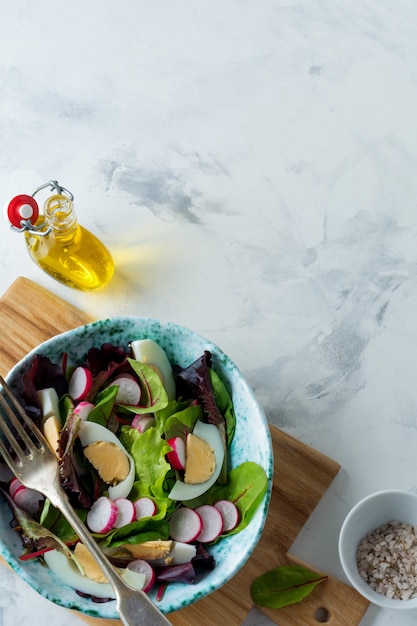 Salad from fresh leaves in a ceramic plate