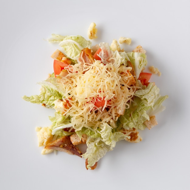 Salad from vegetables and meat on a white background