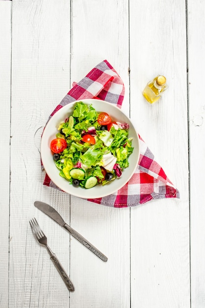 Salad of greens and tomatoes with olive oil.