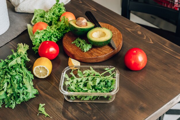 Salad ingredients on wooden kitchen table. Healhy food concept. Selective focus