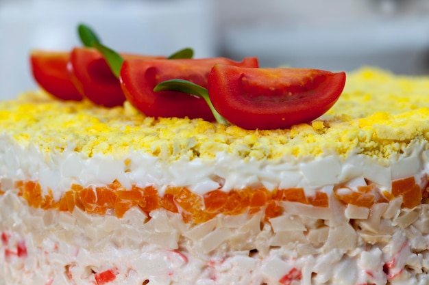 salad made from different ingredients, mayonnaise, carrots, crab meat, eggs, salad of mixed ingredients stacked in several layers