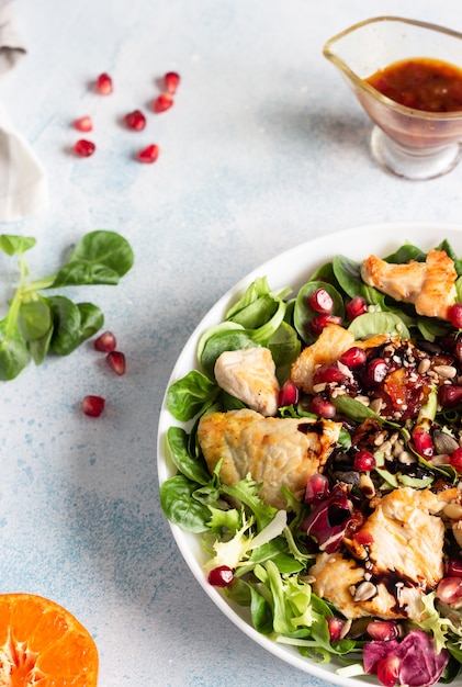 Salad mix with grilled chicken, seeds and citrus dressing